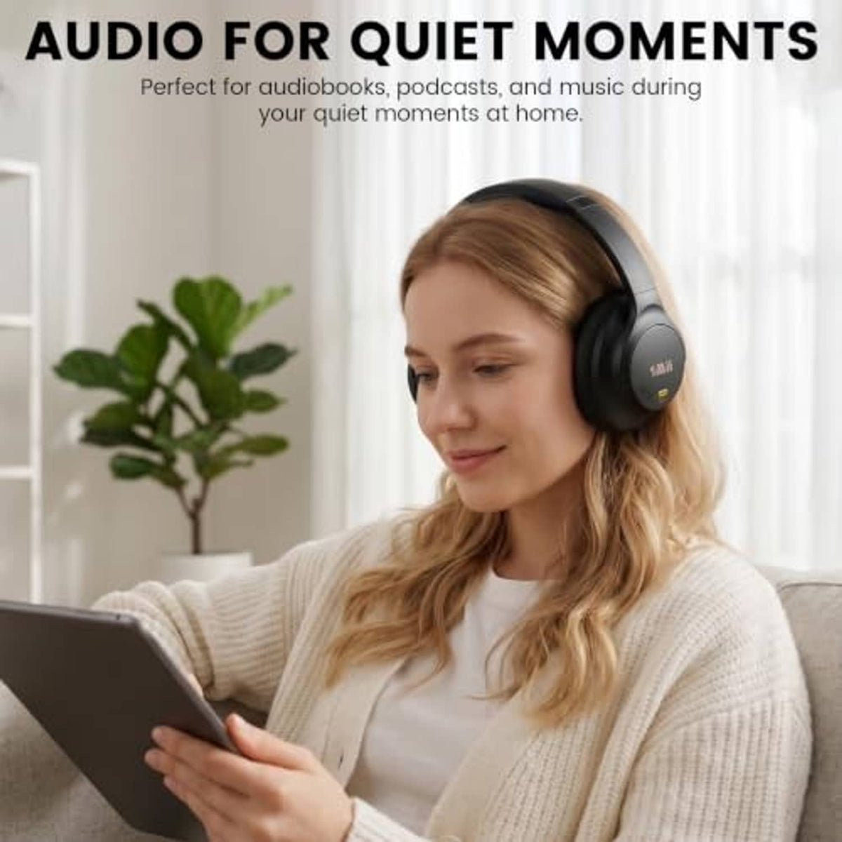 Black over-ear headphones worn by a person, cushioned ear cups and padded headband.