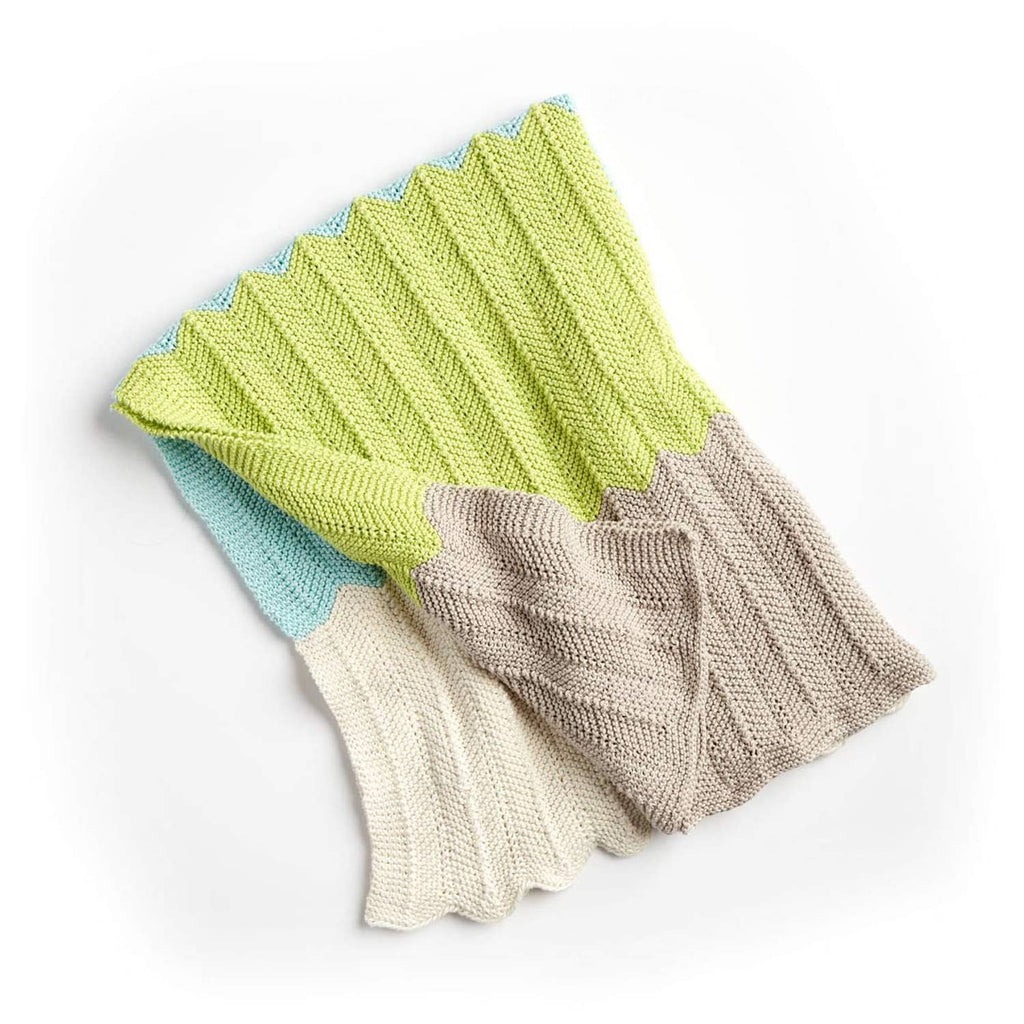 Striped knit baby blanket in green, blue, gray, and cream tones