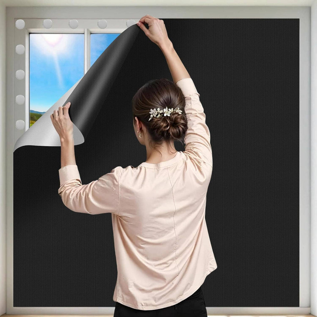 Black blackout window blind cover installed flat, dark fabric covers the window