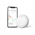Airthings Wave Enhance white indoor air quality monitor with green status light