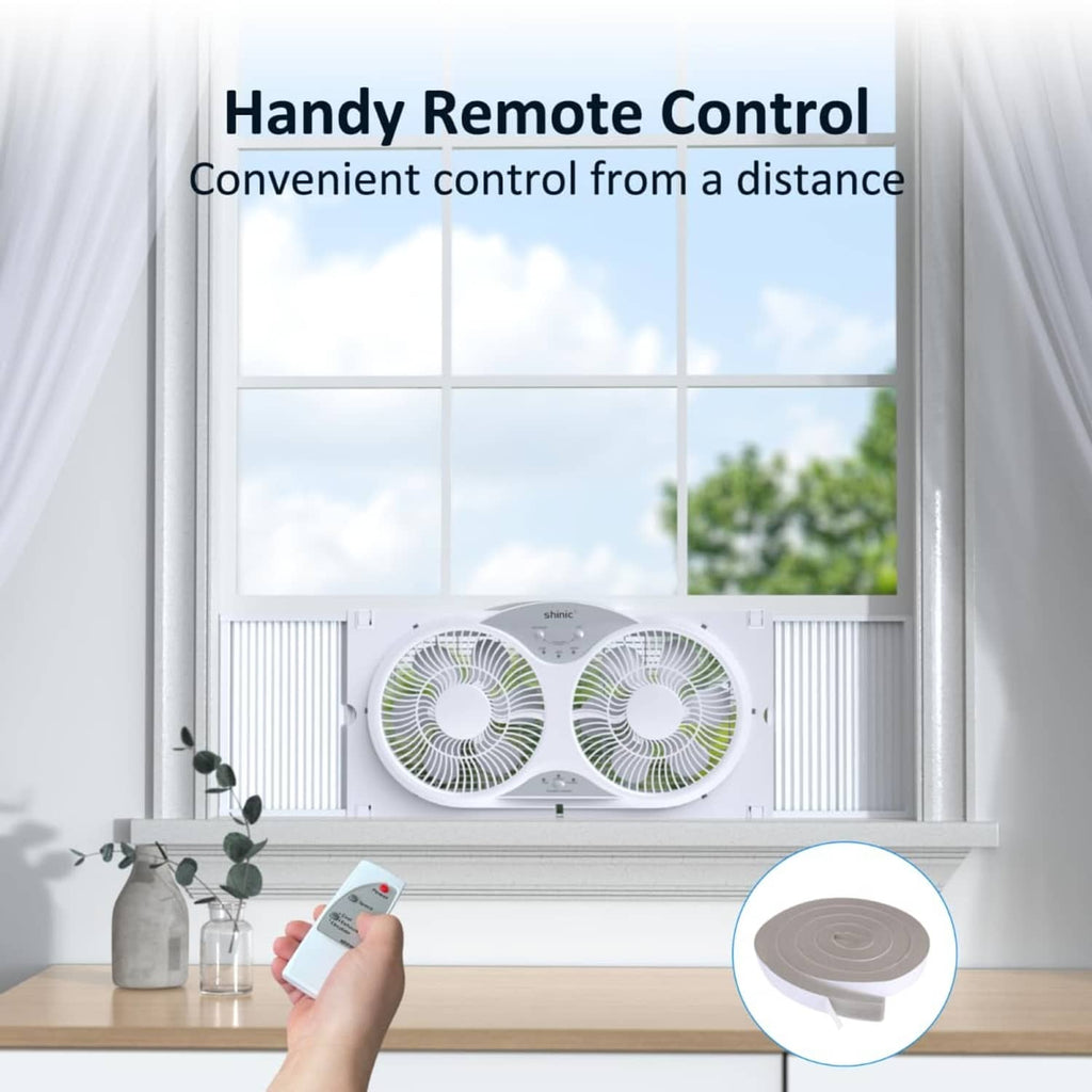 White window fan operating with handheld remote control beside a small dome cover