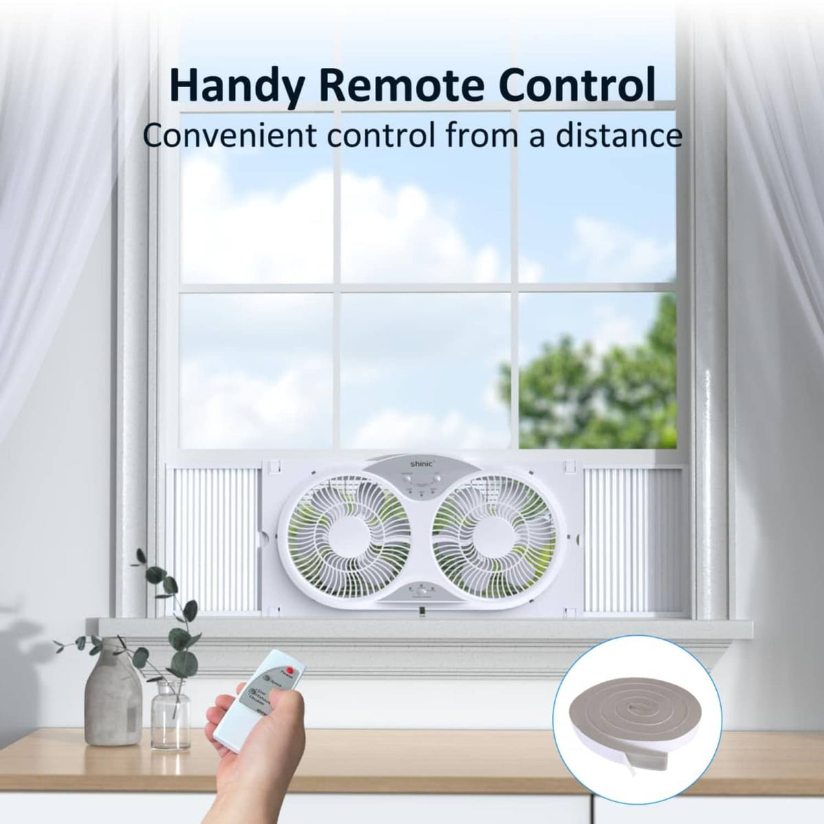 White window fan operating with handheld remote control beside a small dome cover