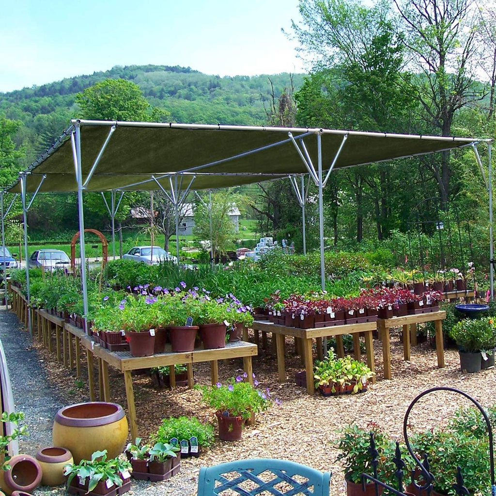 Green waterproof tarp canopy stretched on metal frame over rows of potted plants