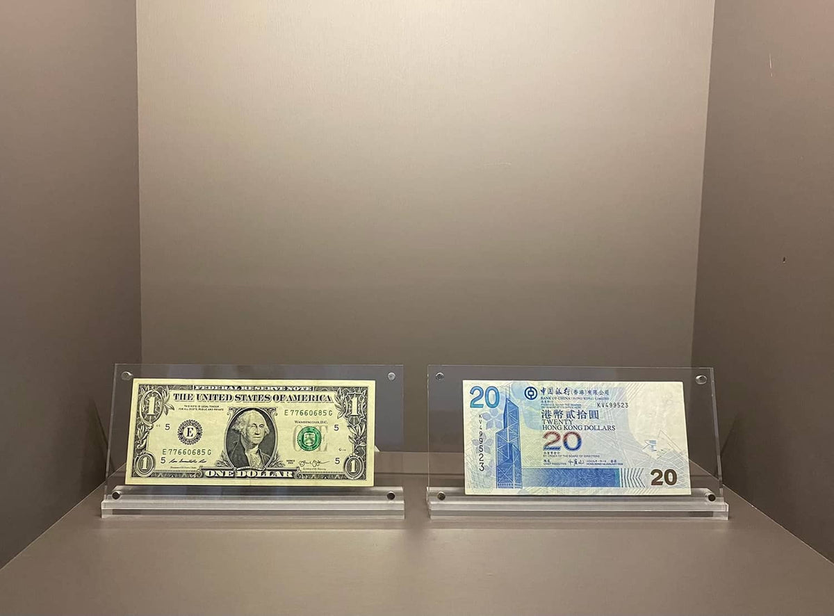 Clear acrylic money display cases for a $1 bill and a blue 20 note