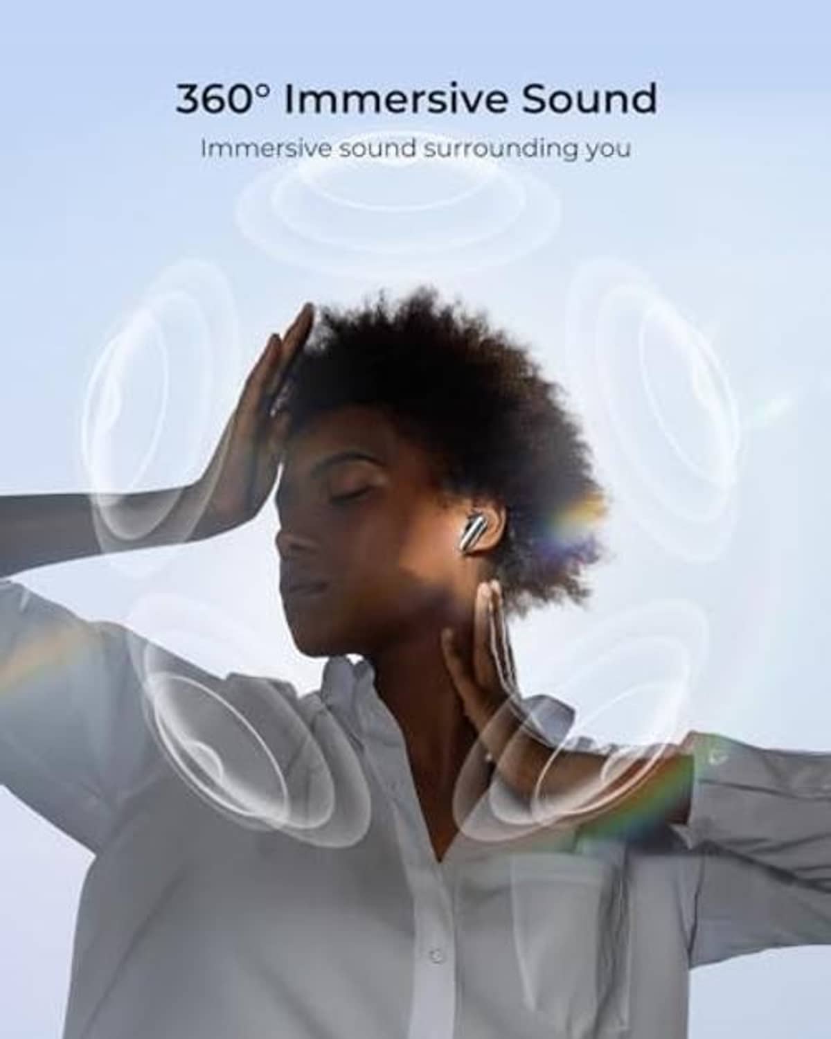 Black wireless earbuds worn by a person in a suit, side view.