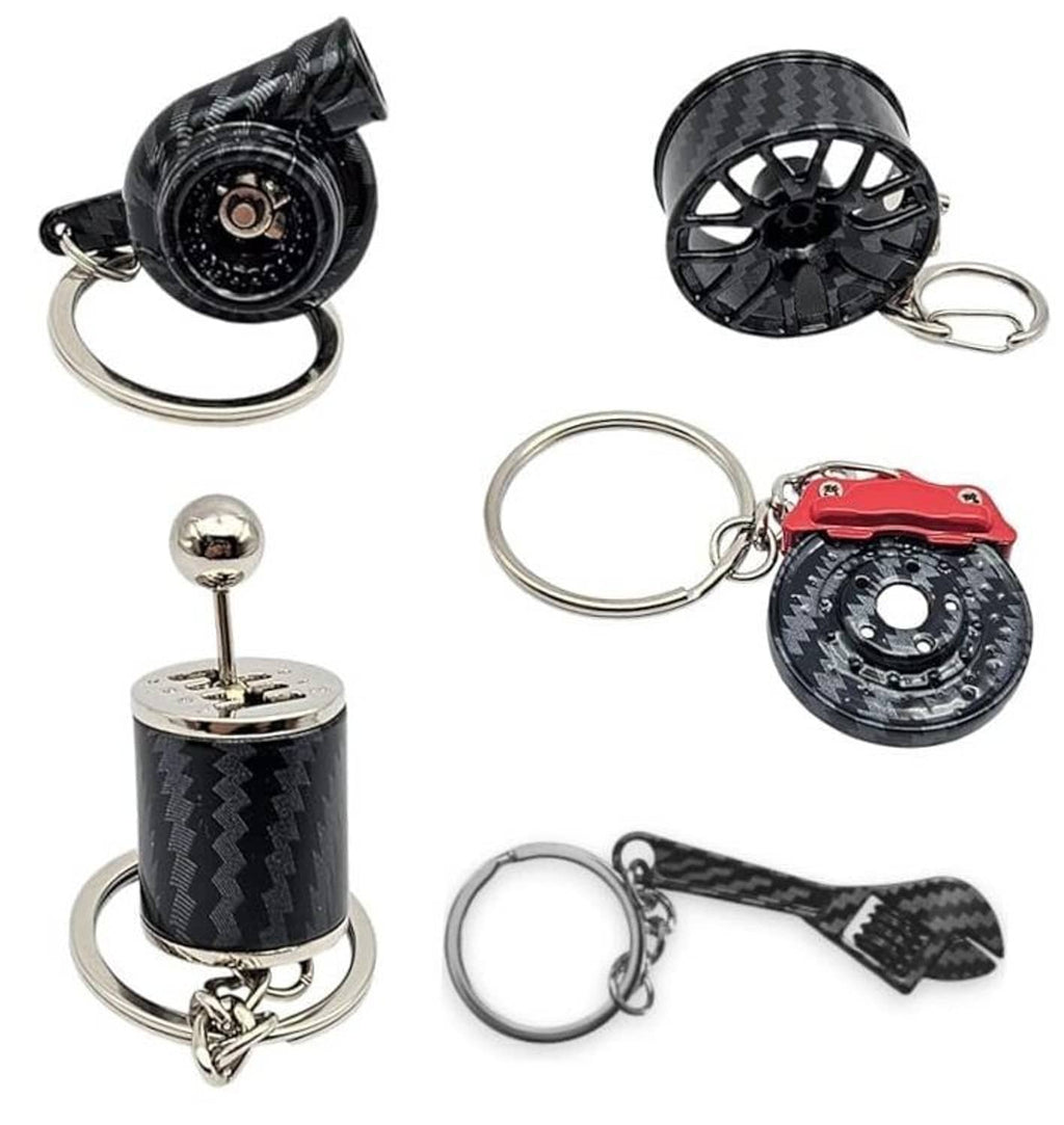 Five-piece carbon-fiber style auto parts keychain set with turbo, wheel, and engine charms