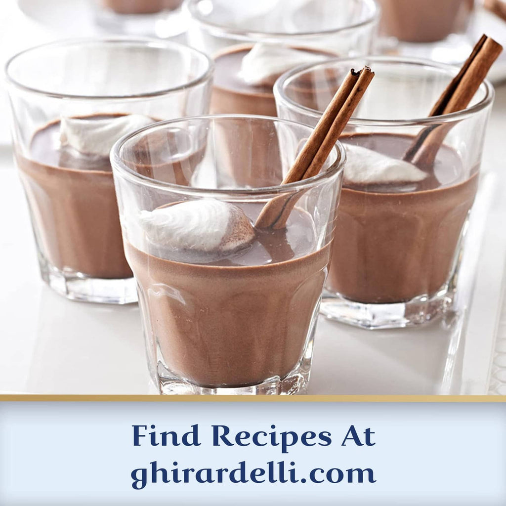 Hot cocoa drinks in clear glasses with cocoa foam and cinnamon sticks