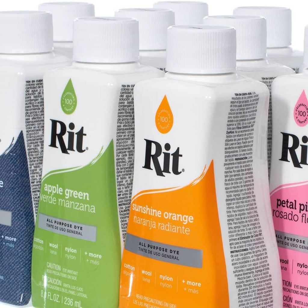 Collection of all-purpose liquid fabric dye bottles with white caps and printed labels