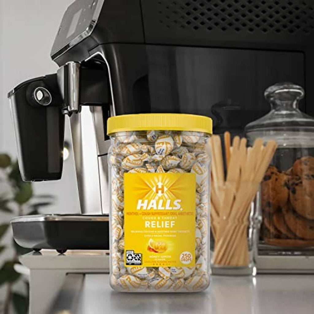 Jar of Halls Relief Honey Lemon cough drops on a kitchen counter