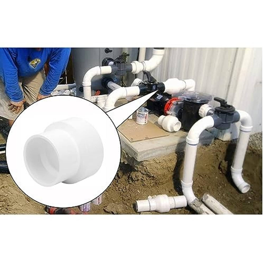 White PVC DWV reducer coupling installed on drain piping, socket-to-socket connection