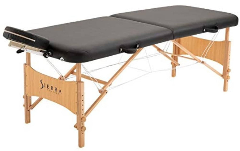 Foldable massage table with black padded surface, face cradle, and wooden base