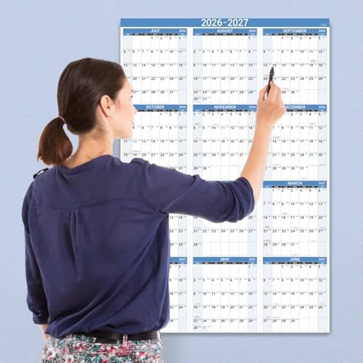 Blue 2026-2027 wall calendar viewed flat, with monthly sections and dates