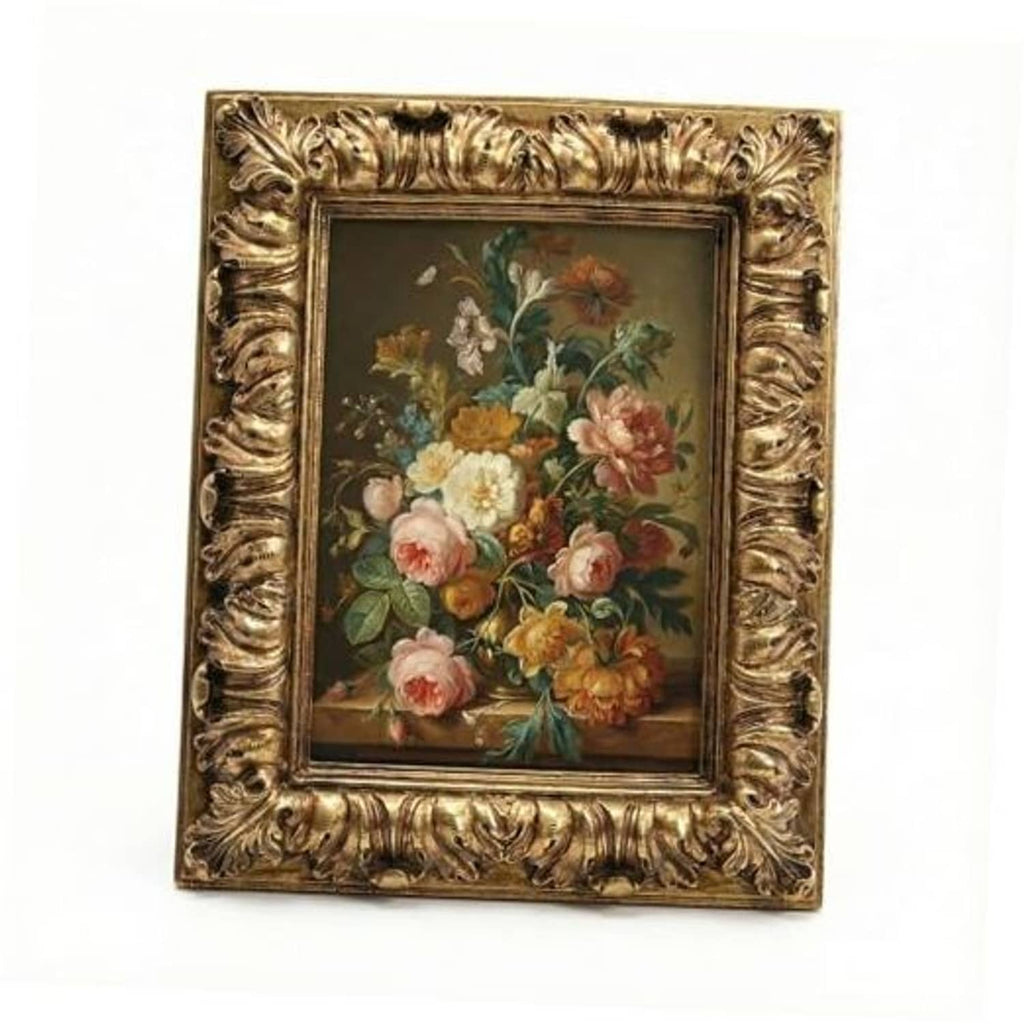Ornate antique gold picture frame with floral artwork inside