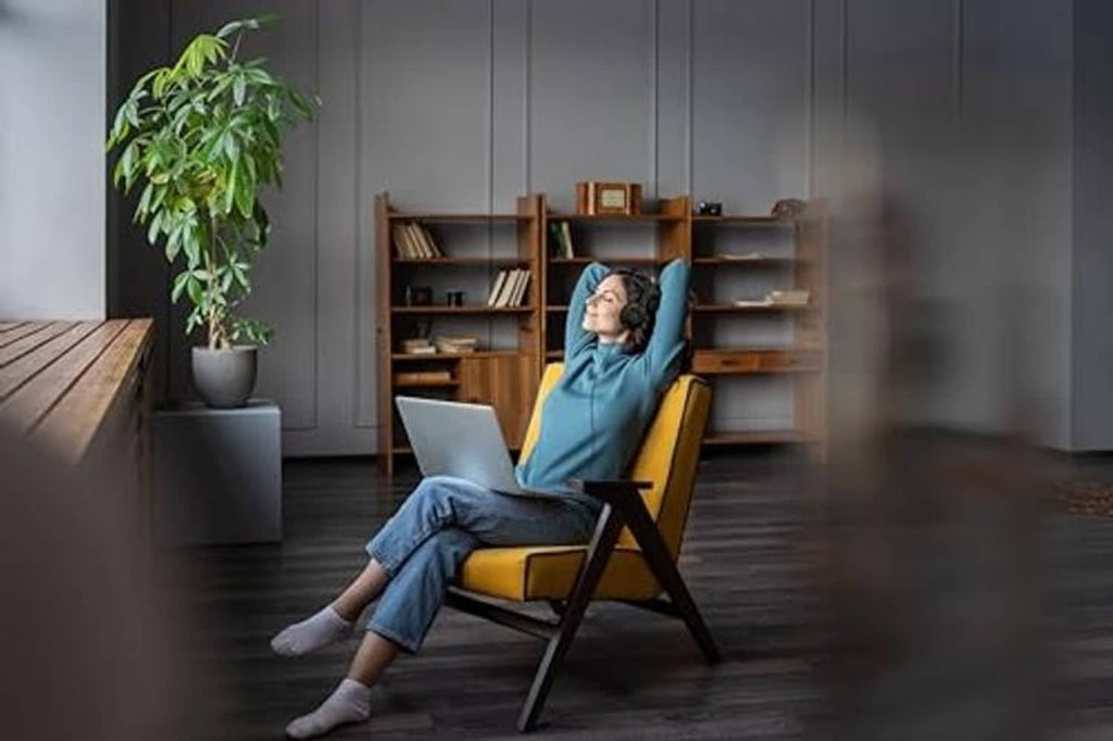 Person relaxing in black USB over-ear headset with microphone