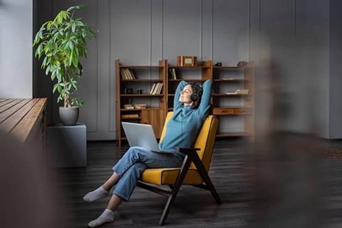 Person relaxing in black USB over-ear headset with microphone