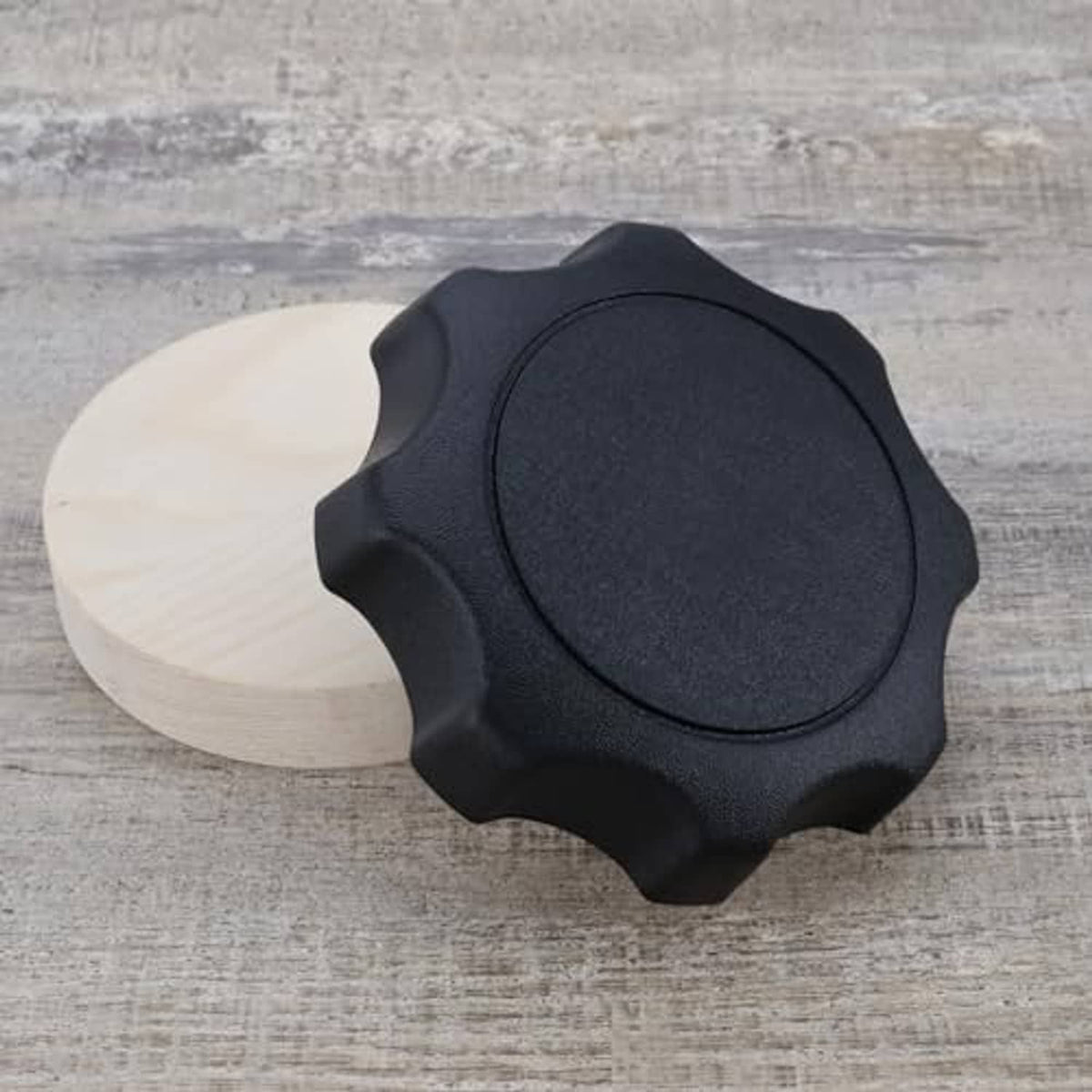 Black car seat adjustment handle knob, round center and textured star edges