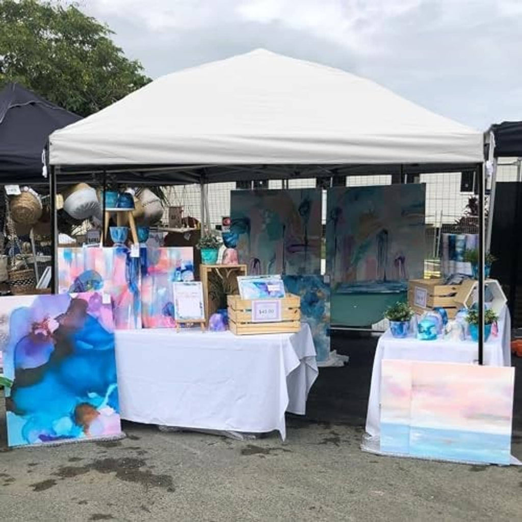 White 10x10 canopy replacement top covering a market display area