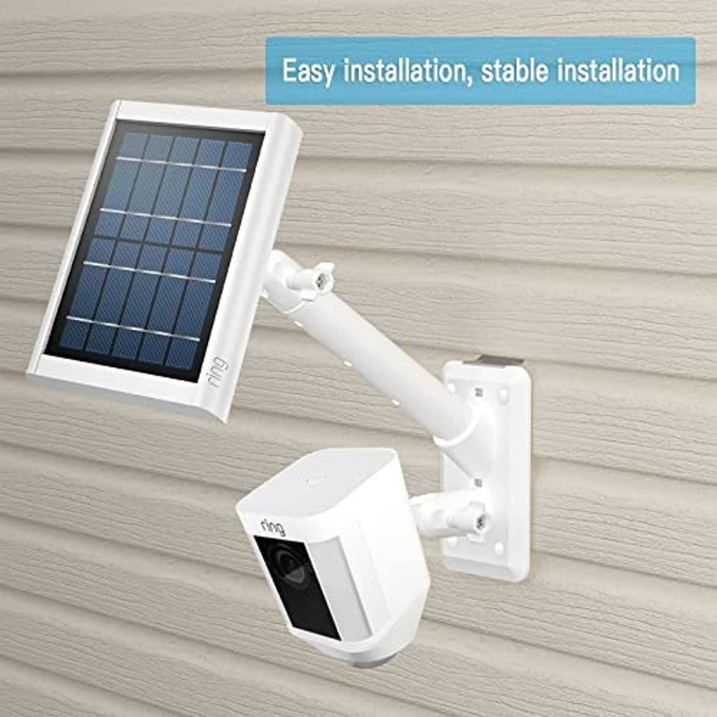 White solar spotlight camera kit with solar panel and wall mount bracket, angled view