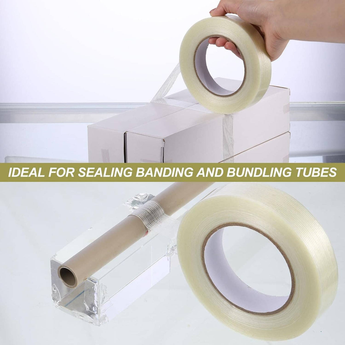 Hand holding translucent strapping tape roll for carton sealing