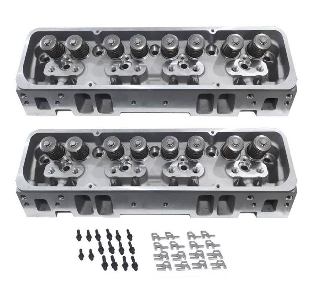 Two aluminum cylinder heads with installed valve springs and hardware bolts