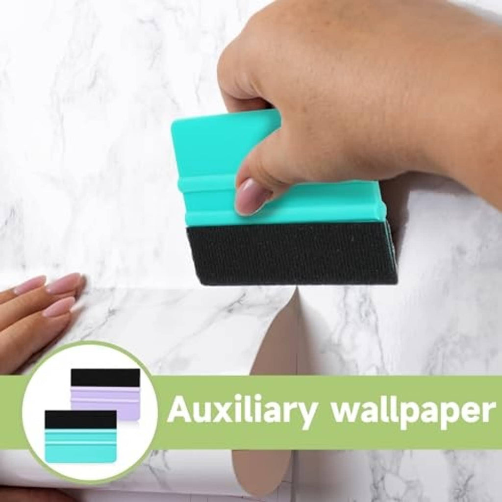 Hand holding turquoise plastic squeegee with black felt edge for vinyl application