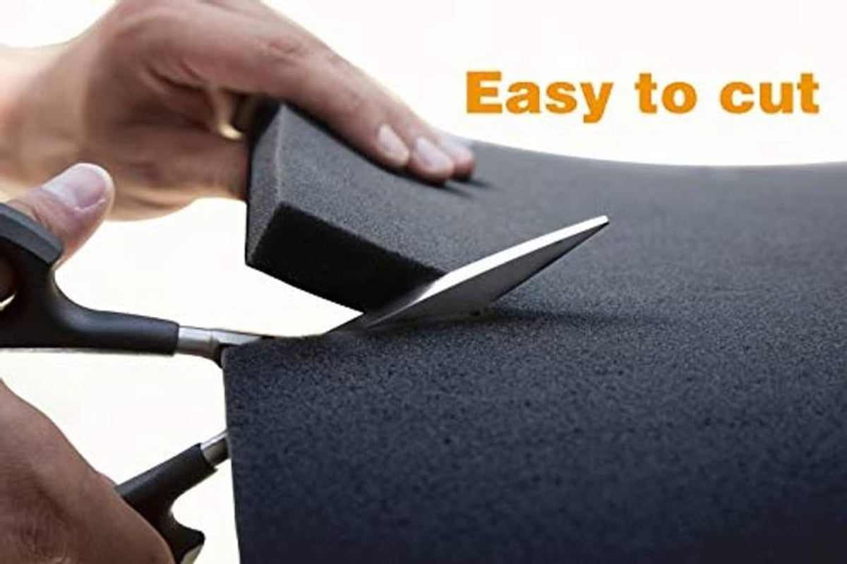 Cutting a dark gray/black foam AC drip cushion with scissors