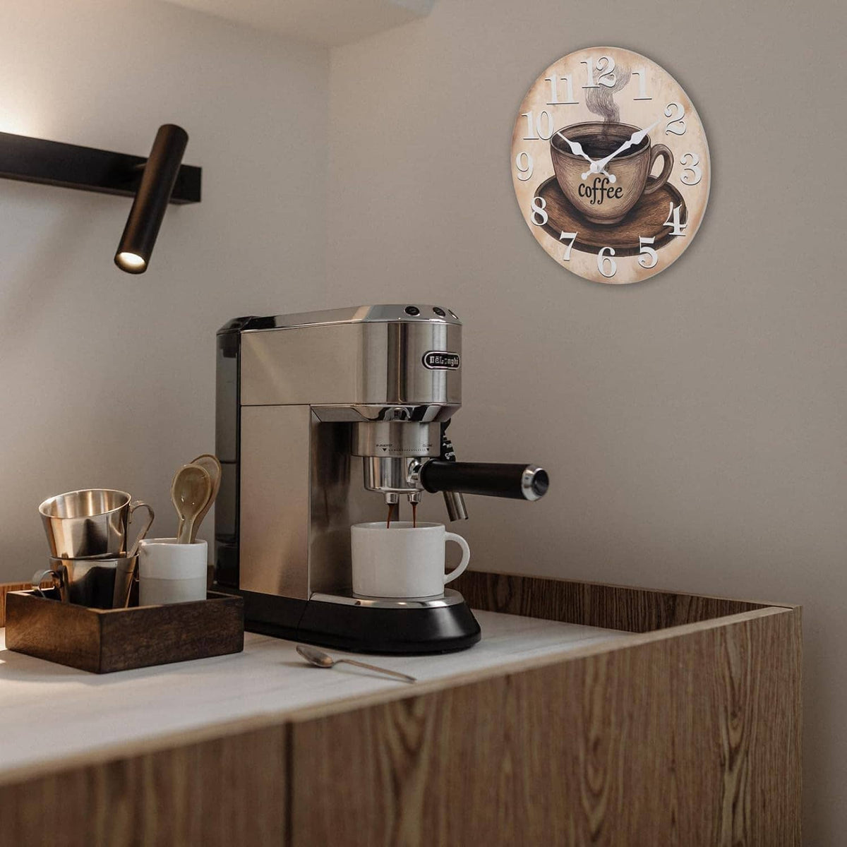 Coffee cup themed round wall clock with vintage numerals and white hands on a wall