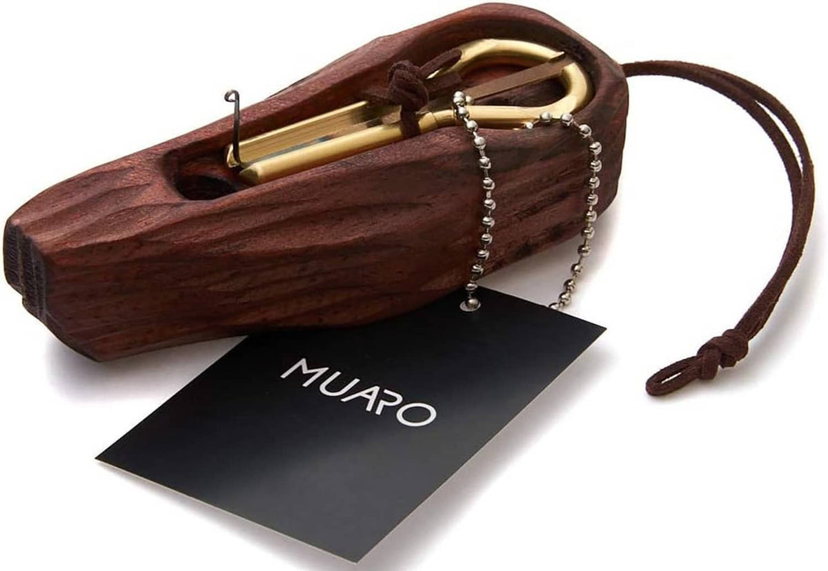 Brown wooden jew's harp case with gold-tone mouth instrument, chain, and cord.