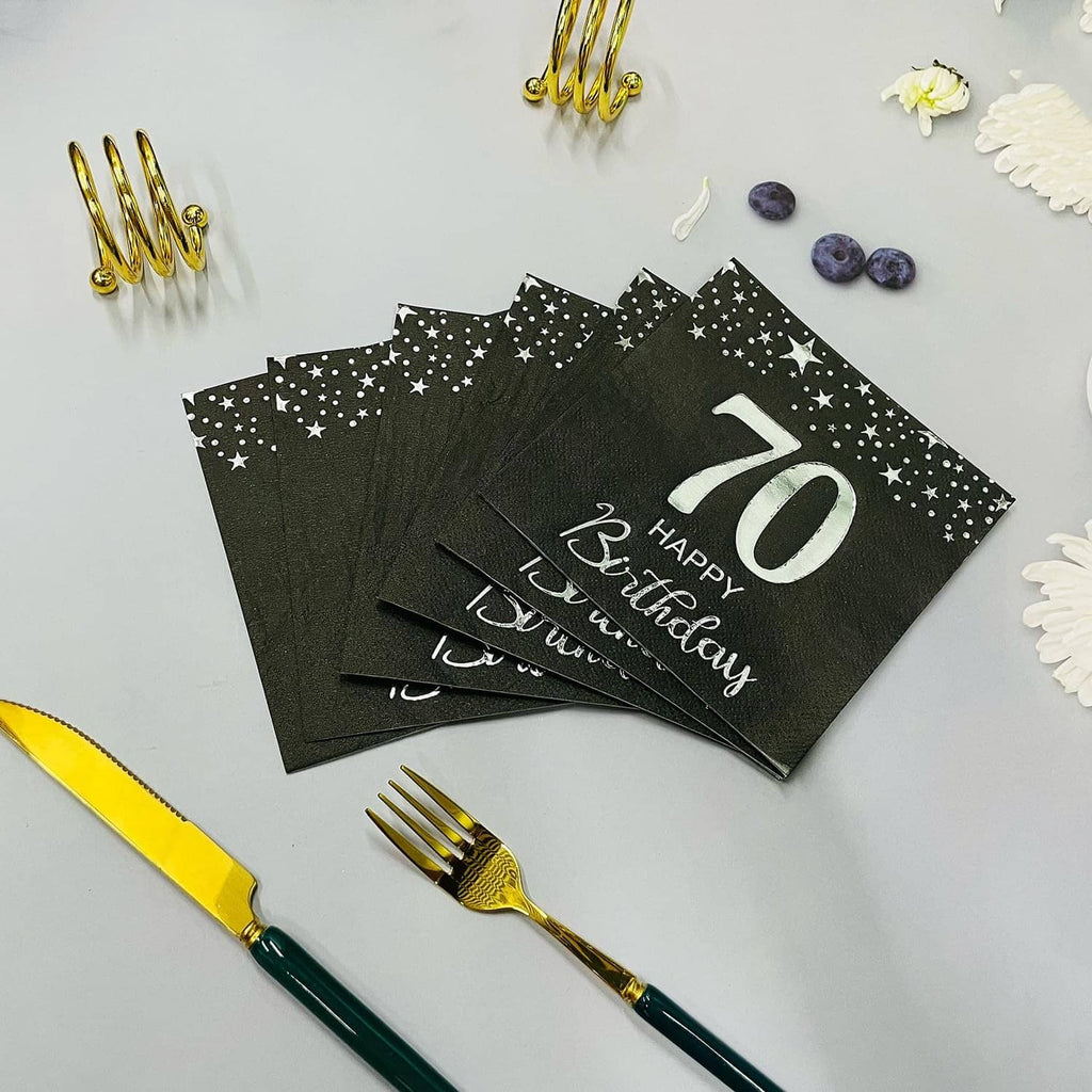 Stack of black star 70th birthday napkins with silver “70 Happy Birthday” lettering