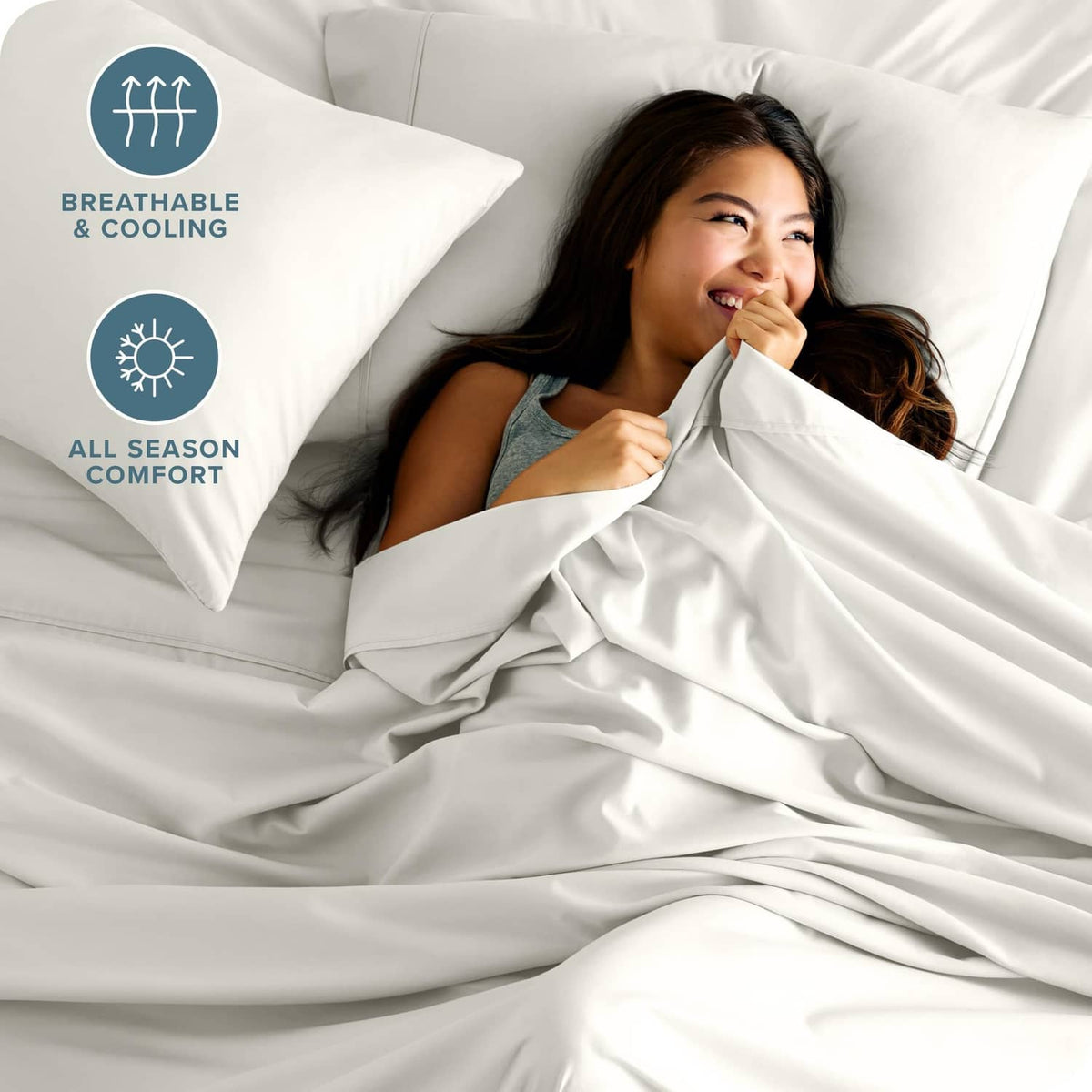 Cream microfiber bed sheet set with smooth fabric draped across pillows and duvet