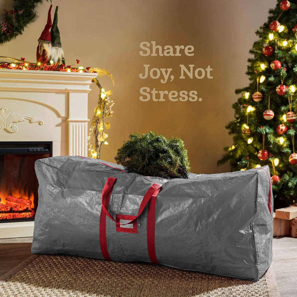 Gray Christmas tree storage bag with red handles, laid flat for storage