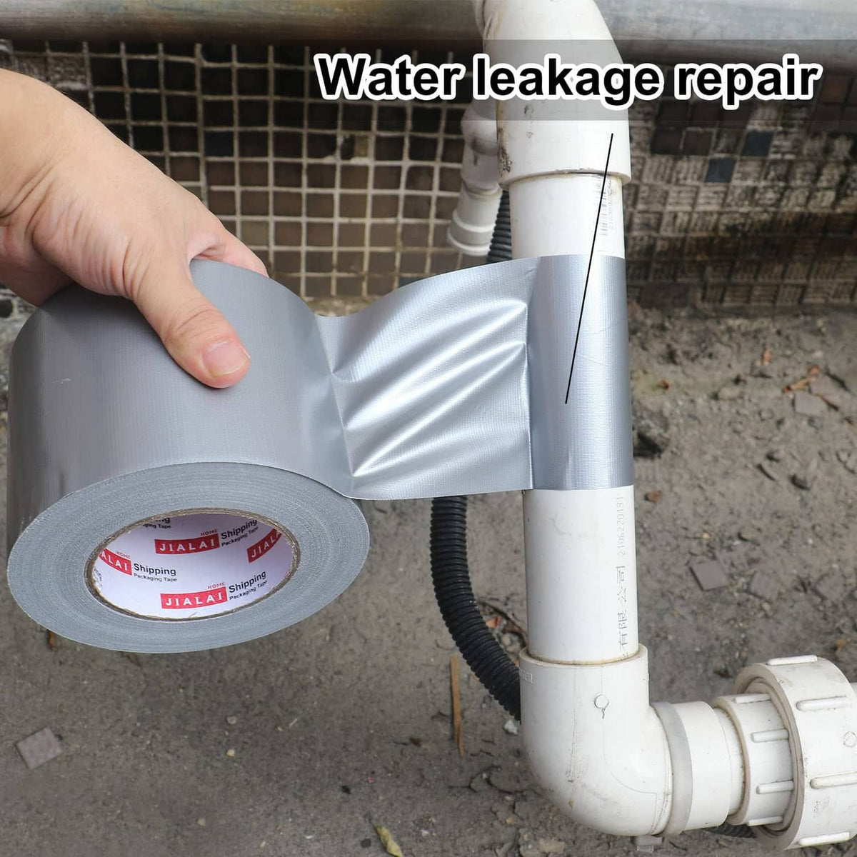 Silver duct tape strip applied to a plumbing pipe joint for leak repair.