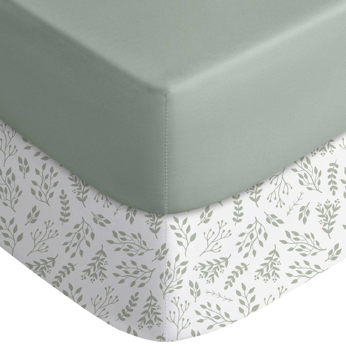 Fitted crib sheet with light green solid top and white leaf-print skirt corners