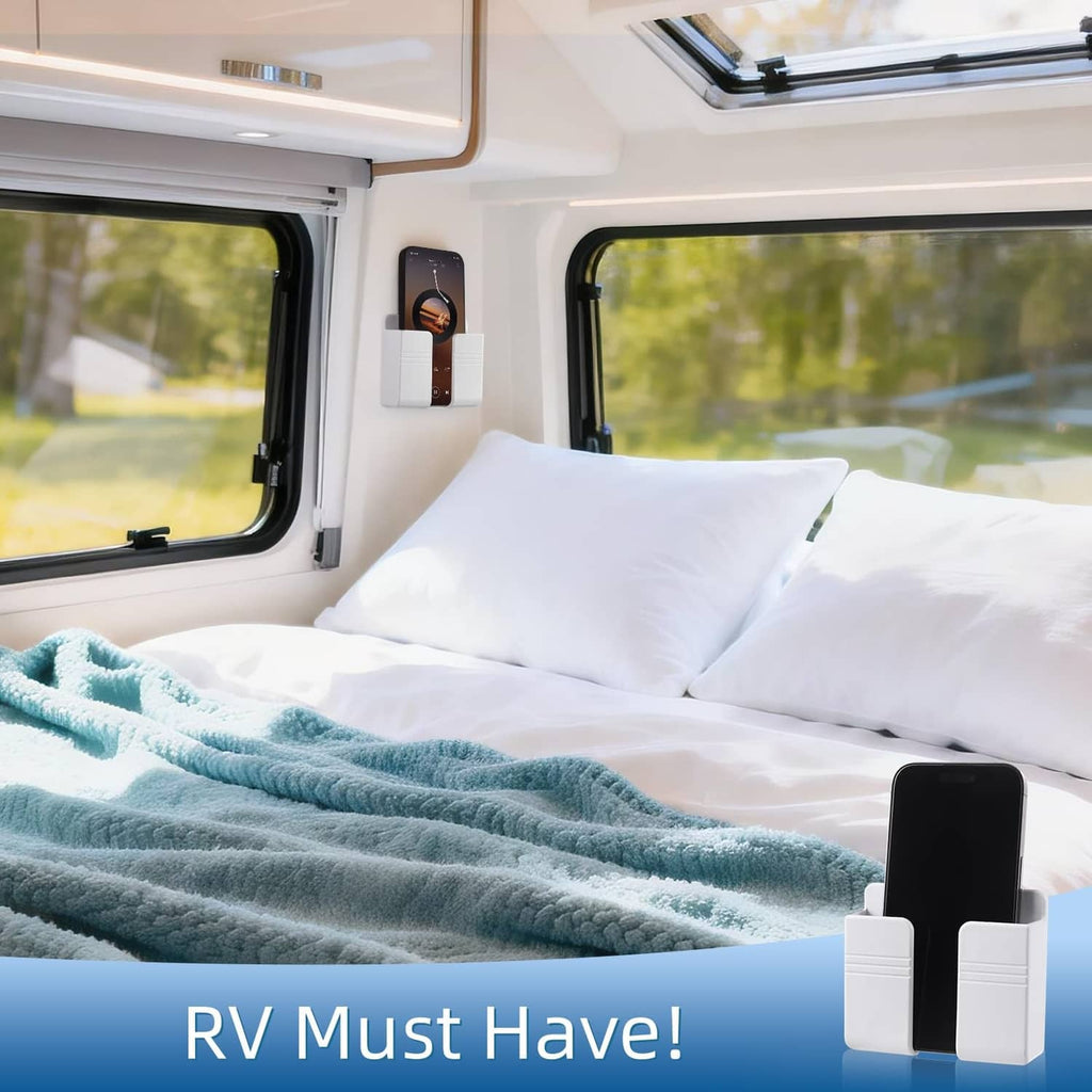 White wall-mounted phone holder clipped to a camper interior wall