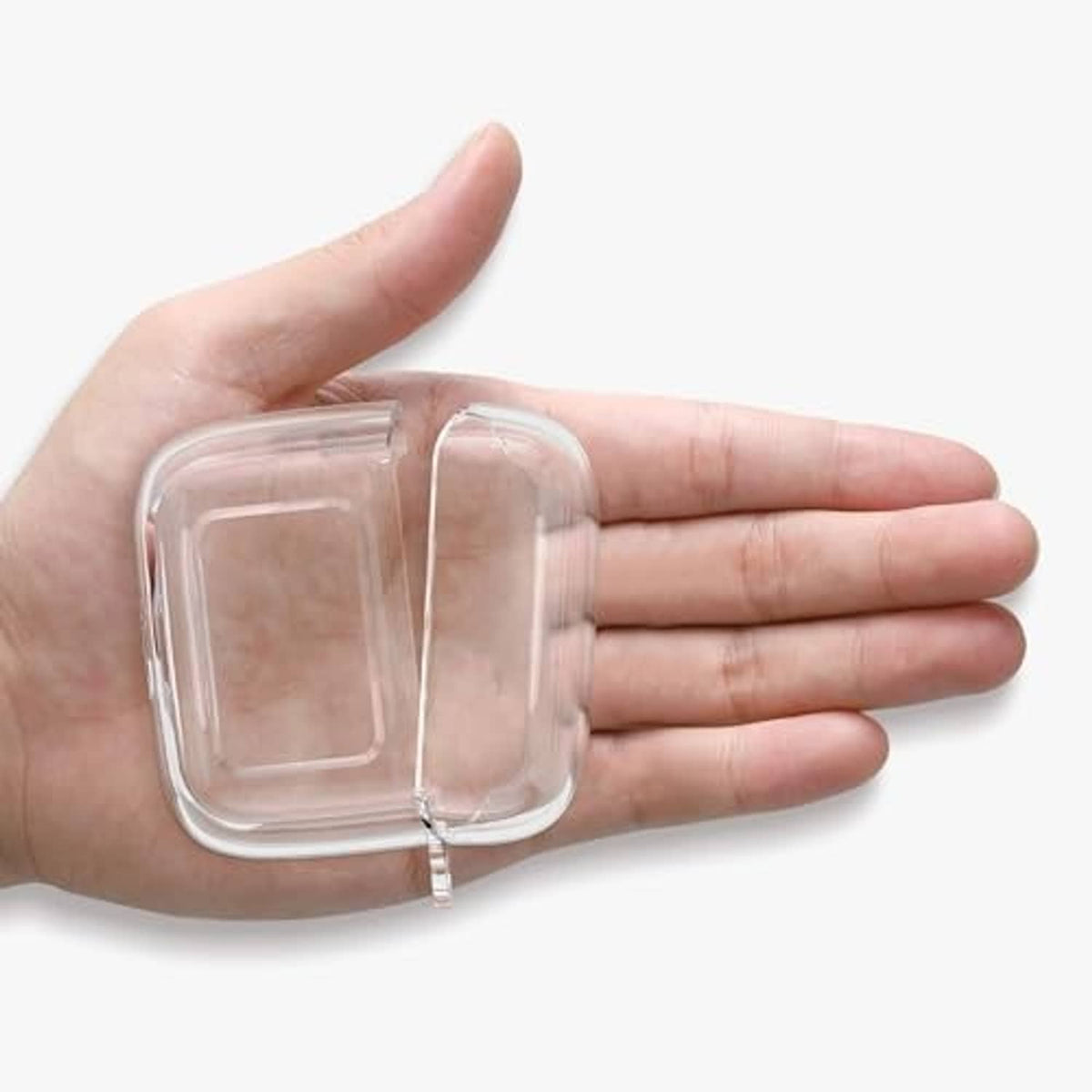 Clear TPU earbud charging case cover held in hand, see-through design.