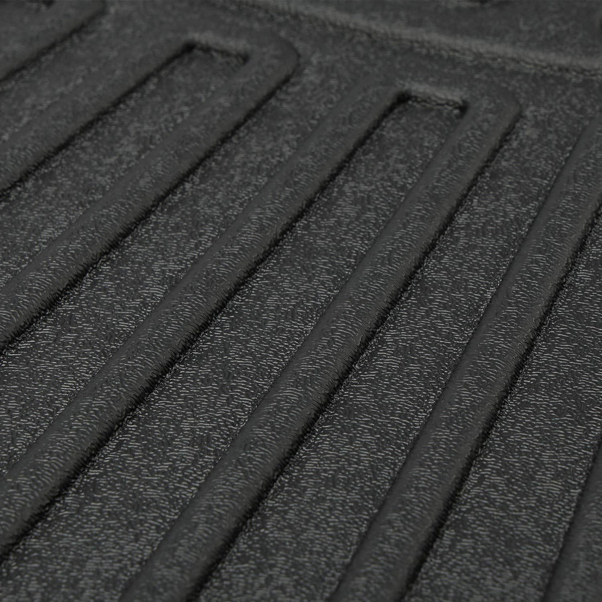 Close-up of black floor mat liner with textured grip ridges