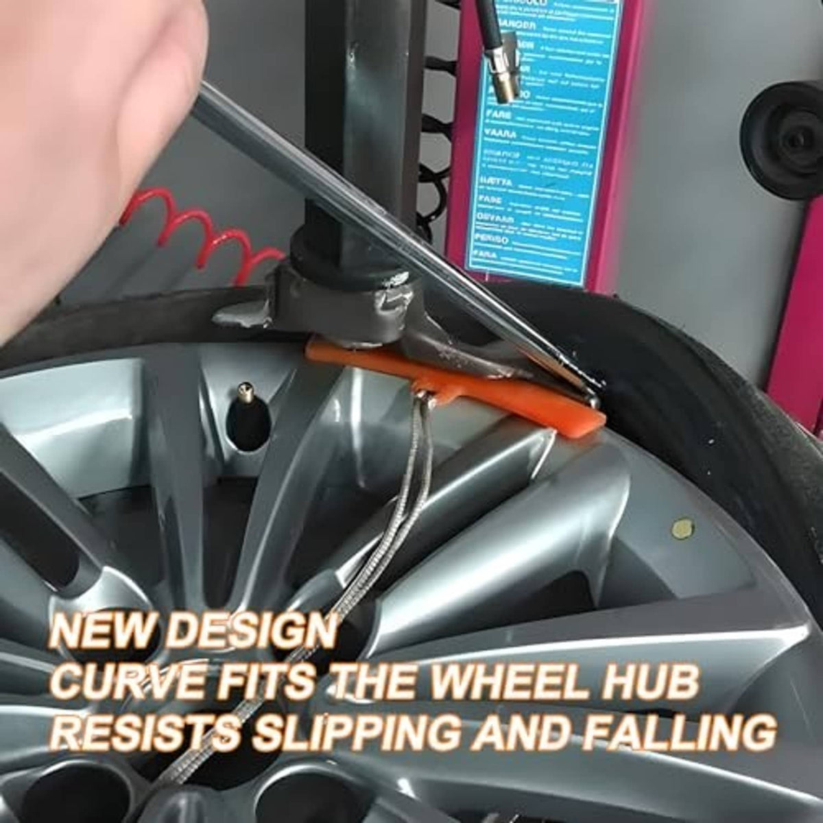 Orange rim protector strip placed on a vehicle wheel during tire changing.