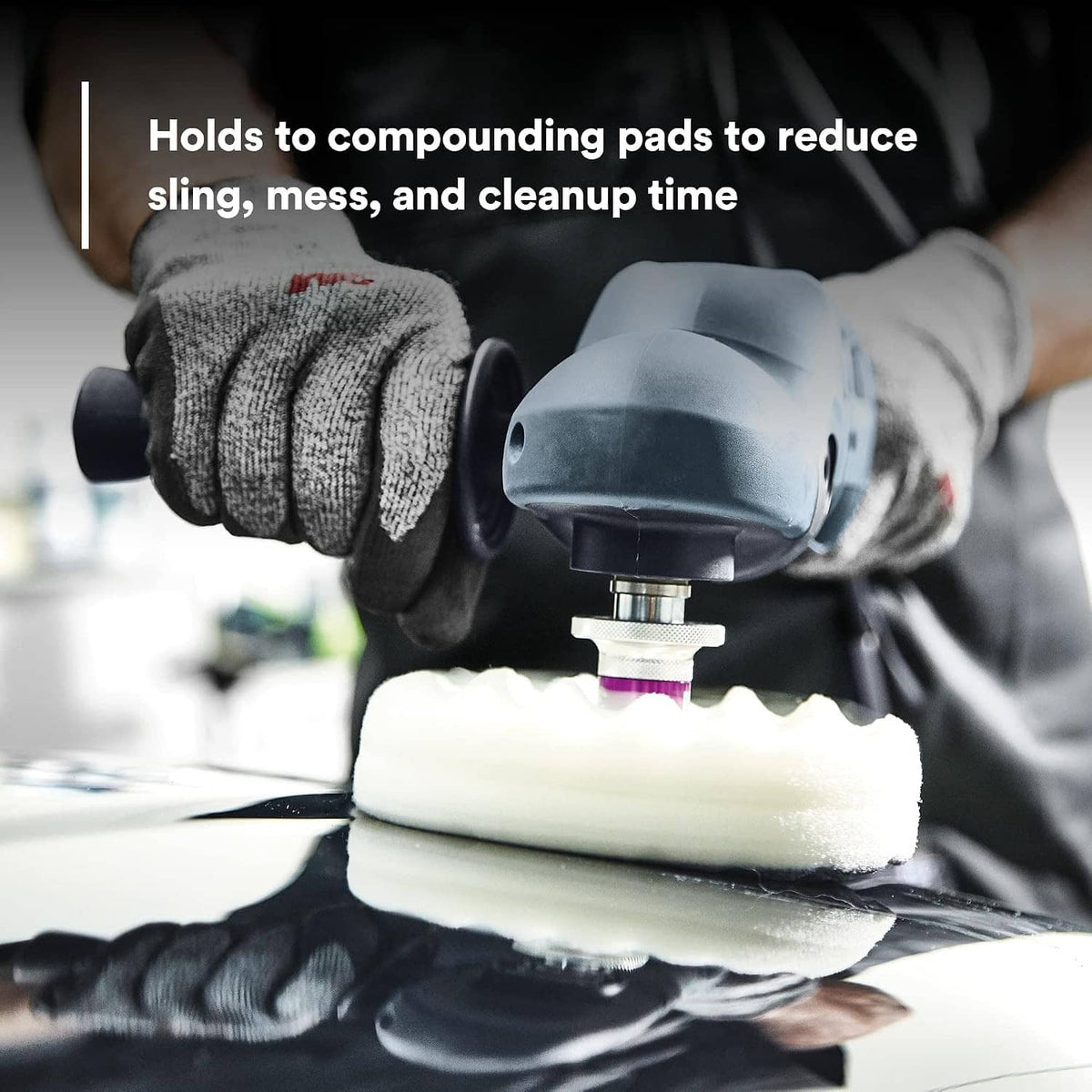 Foam polishing pad holding rubbing compound on polisher, gloved hands