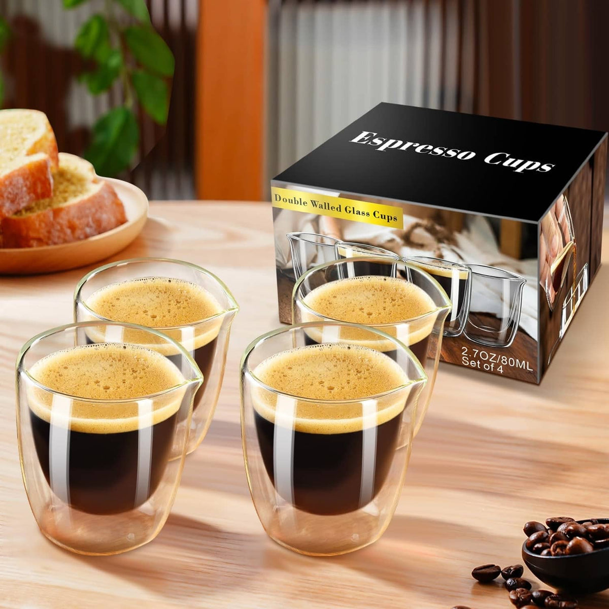 Clear double-wall espresso cups with foam tops and side handles on a wooden table