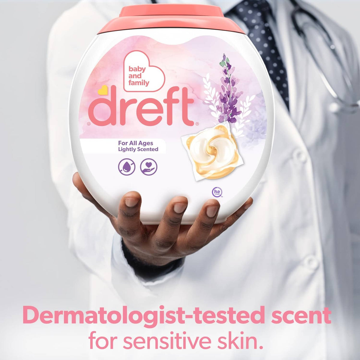 Dreft lightly scented detergent bottle held by a caregiver in white coat