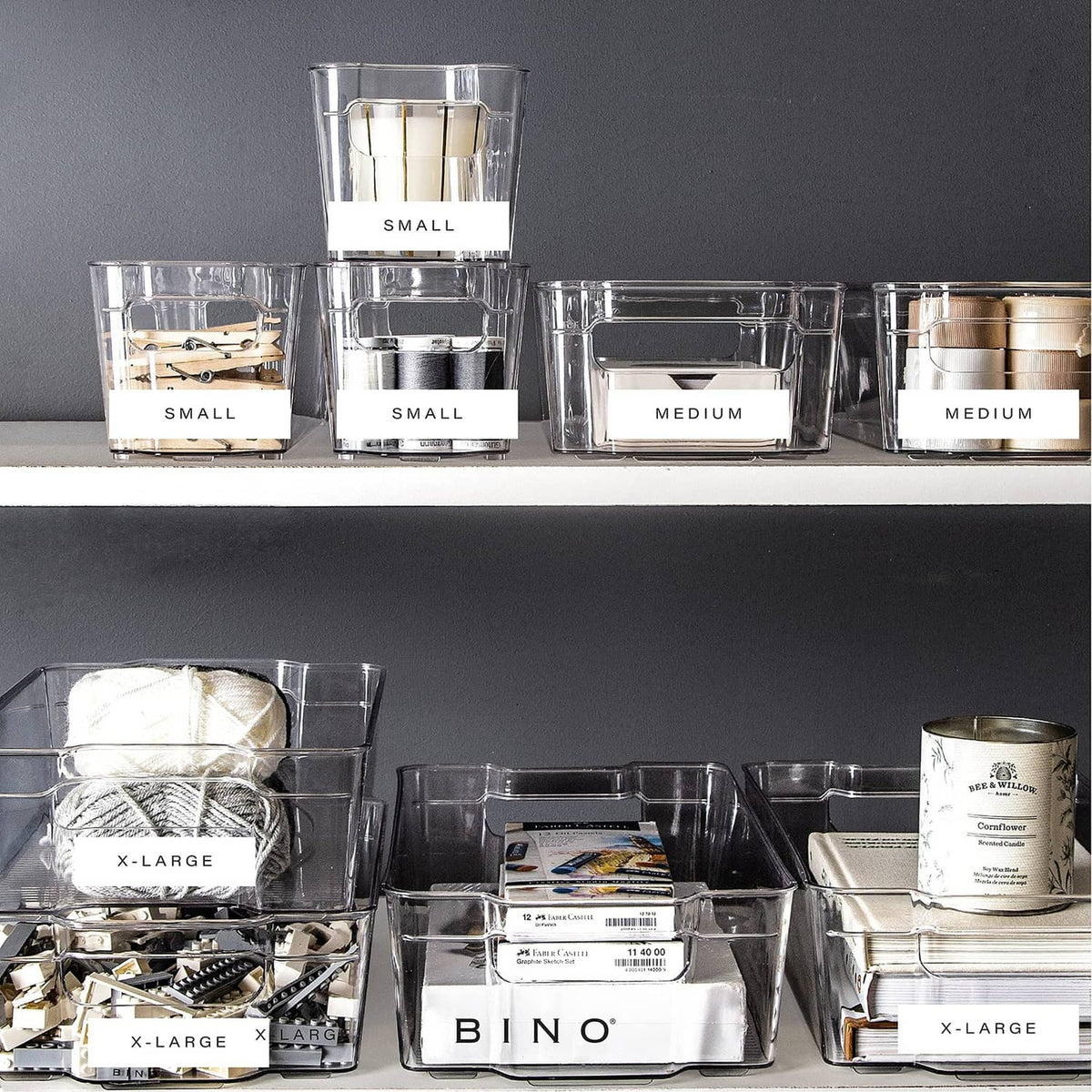 Assorted clear stackable storage bins in small, medium, and x-large sizes