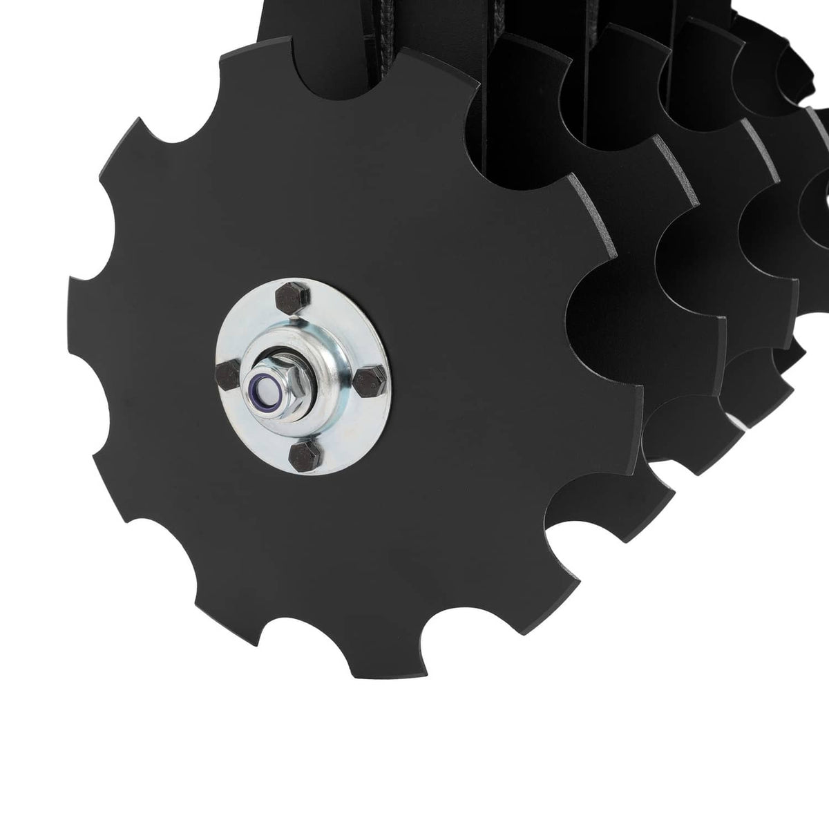 Notched steel disc blade with center hub and mounting nut on disc harrow