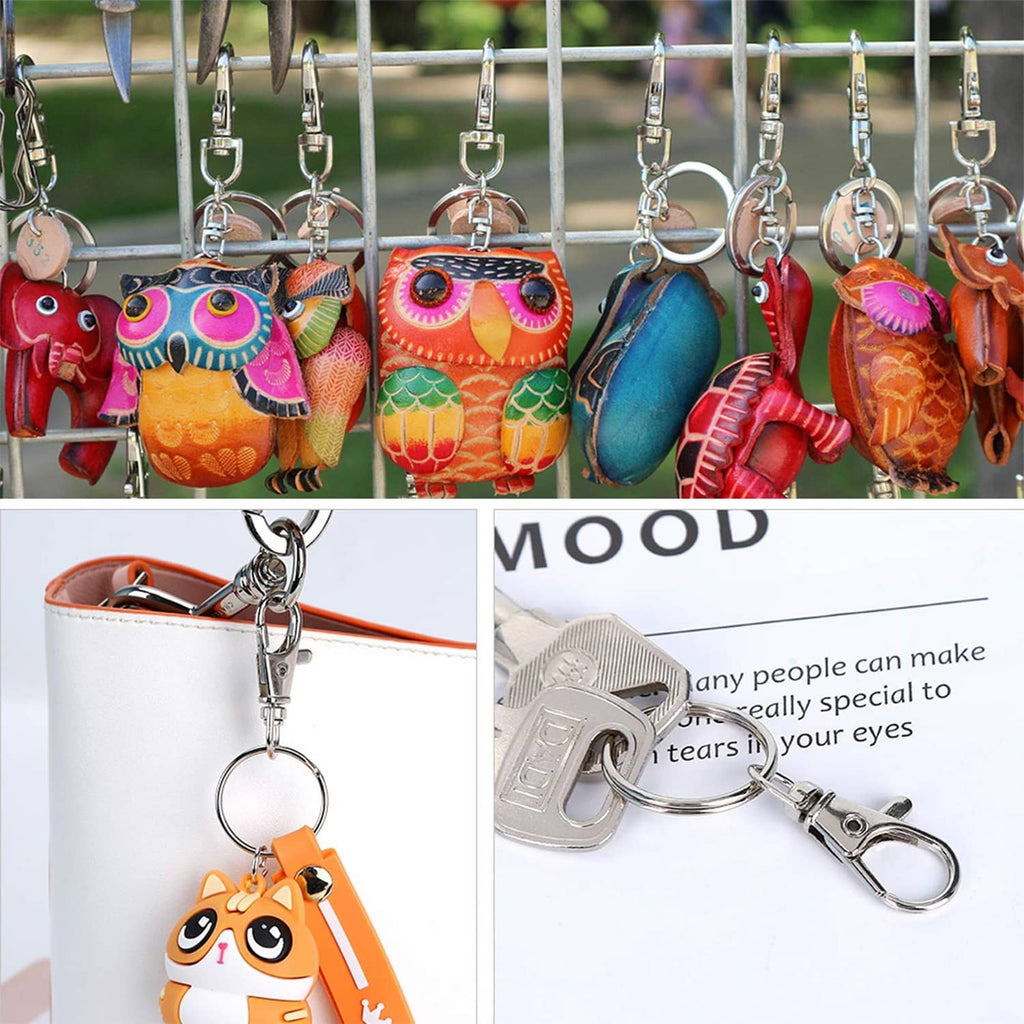 Set of metal swivel snap hooks with key rings hanging from a bar