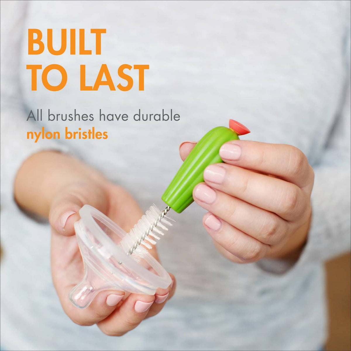 Green cactus bottle brush with nylon bristles shown in hand