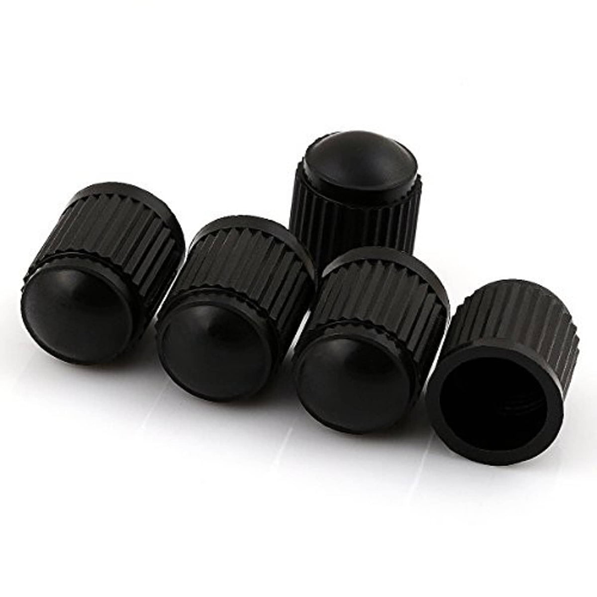 Five black ribbed plastic valve stem caps, rounded tops and open ends