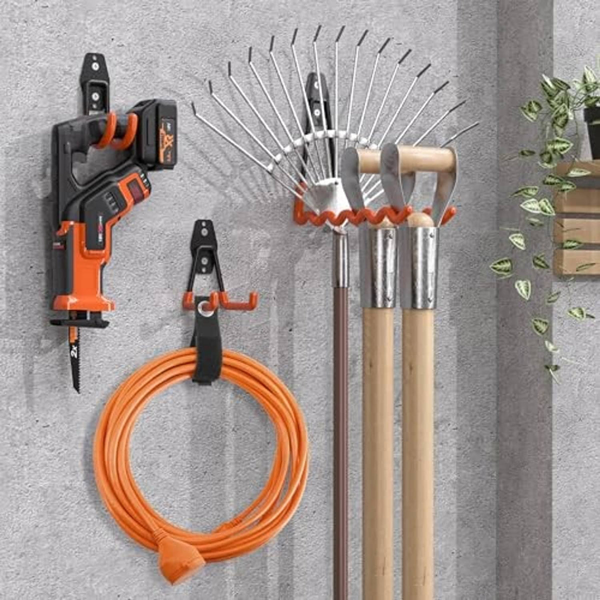 Black garage hooks mounted on concrete wall, holding an orange cable and wooden dowels