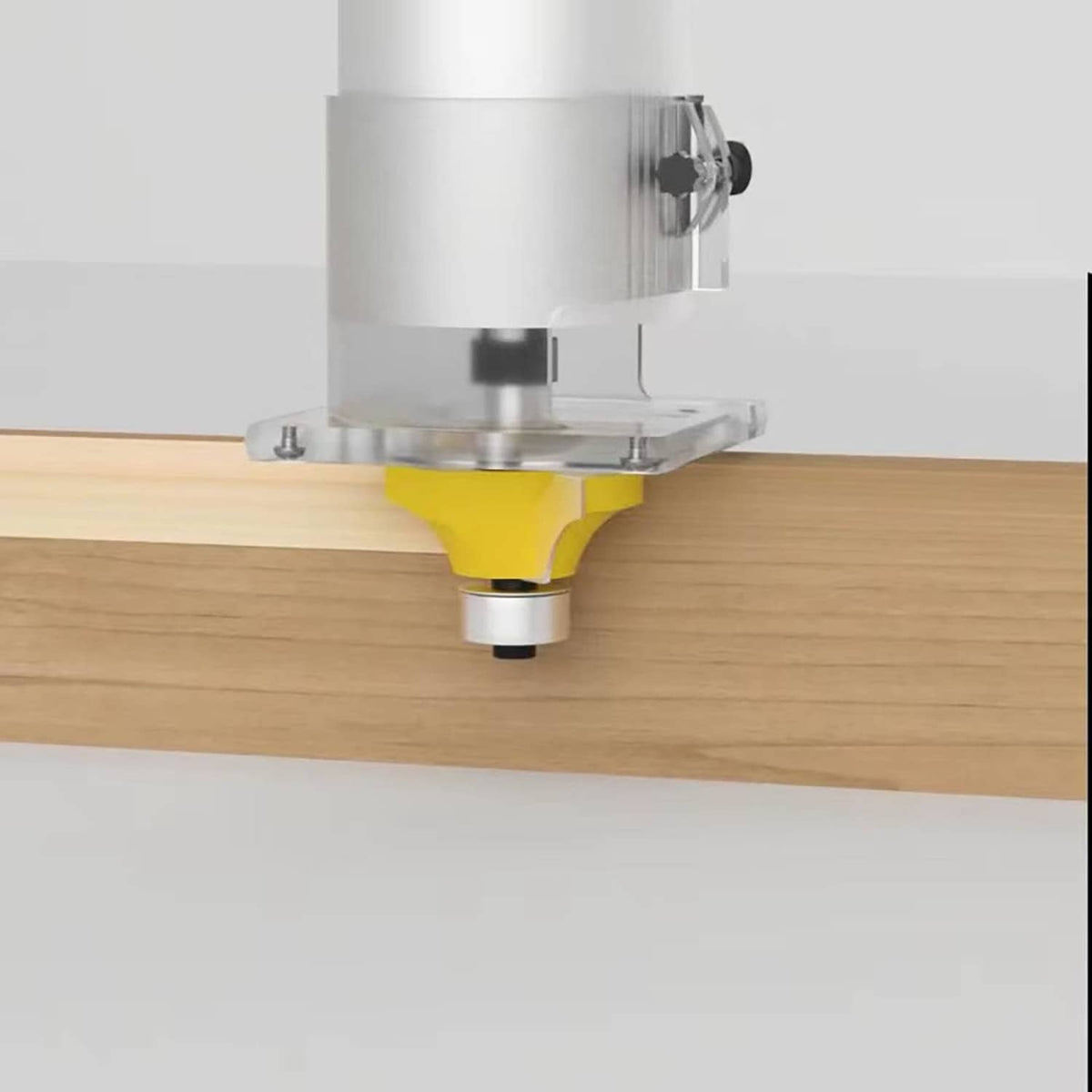 Roundover router bit with yellow carbide cutter and guide bearing routing an edge on wood