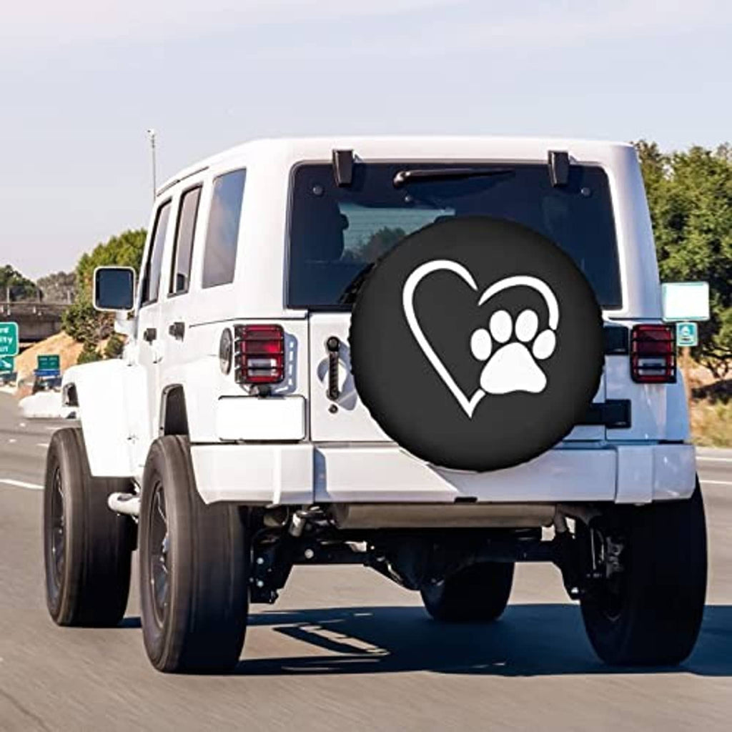 Heart-and-paw spare tire cover on a white SUV rear