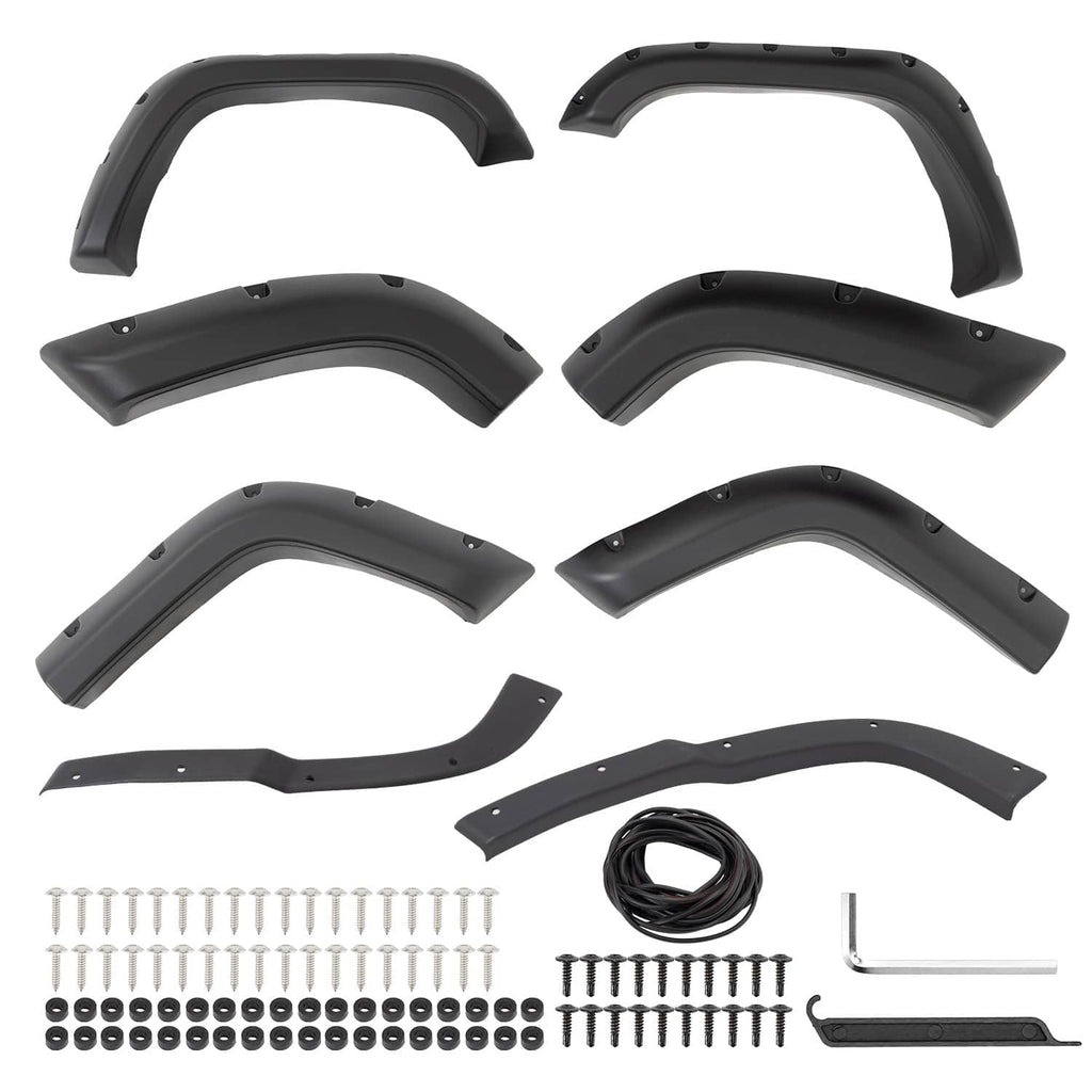 Black fender flare set laid out with screws, clips, and mounting hardware