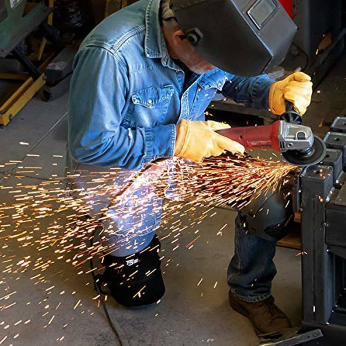 Black leather knee pads worn by welder with protective plates